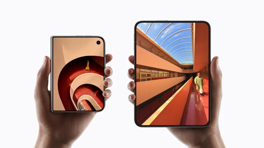 Two hands holding a closed and an opened iPhone Duo side by side