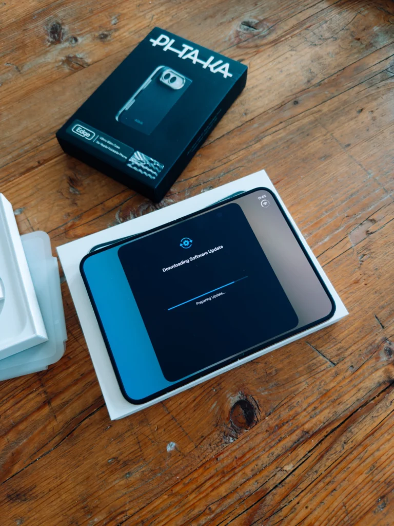 PITAKA Edge case box next to the unfolded iPhone Duo